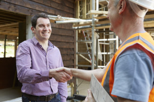42647602 - customer shaking hands with builder